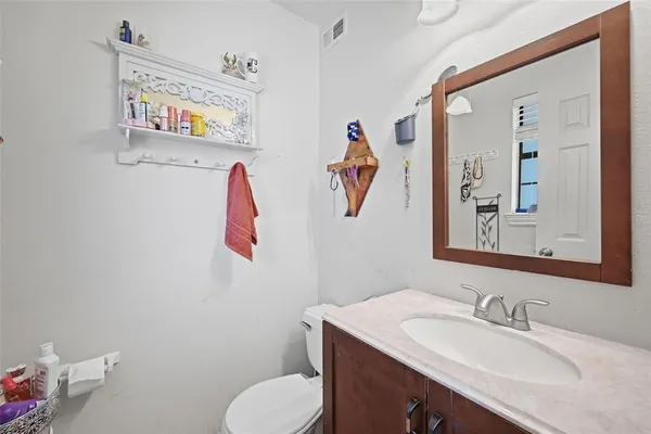 a bathroom with a sink toilet and vanity