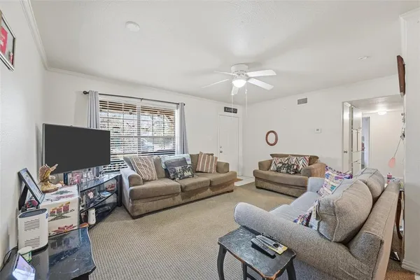 a living room with furniture a large window and a flat screen tv