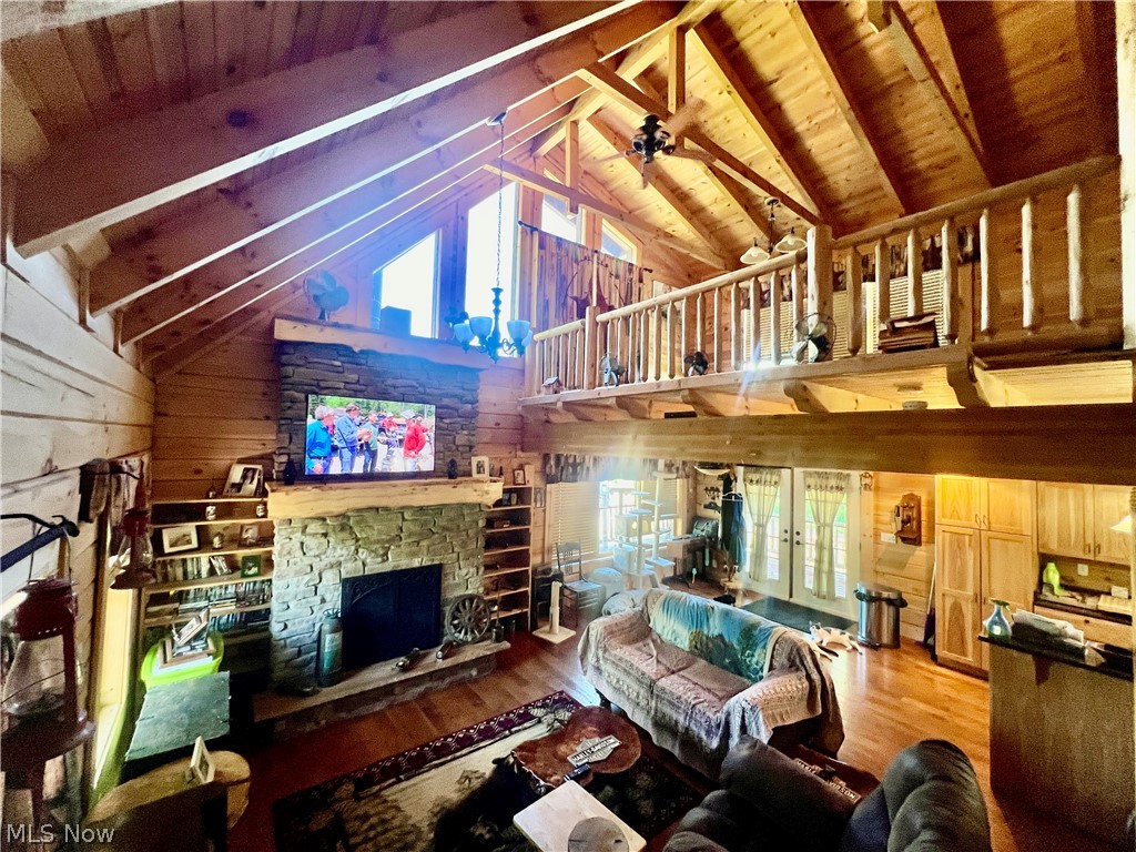 39589 National Road Bethesda, OH 43719 - Photo 8 of 35 Living room featuring a fireplace, wood walls, hardwood / wood-style floors, wood ceiling, and beamed ceiling