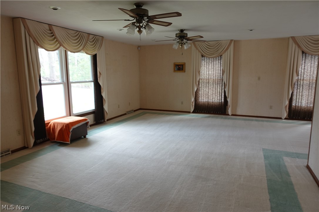 15488 Hatfield Road Rittman, OH 44270 - Photo 15 of 36 Carpeted empty room with ceiling fan