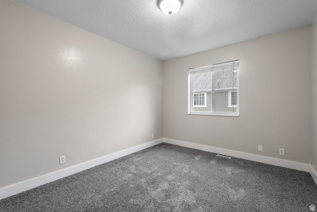 273 West 1010th Street South Logan, UT 84321 - Photo 16 of 19 Carpeted empty room with baseboards and a textured ceiling