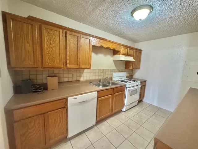 a kitchen with stainless steel appliances granite countertop a sink and cabinets