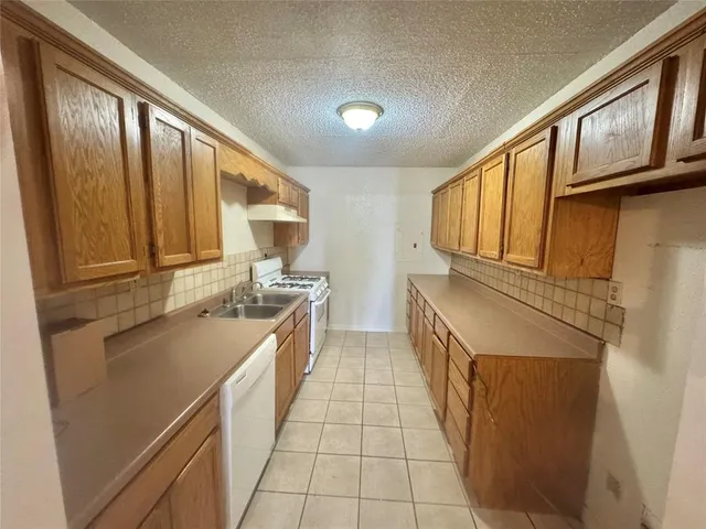 a kitchen with stainless steel appliances granite countertop a stove and a refrigerator