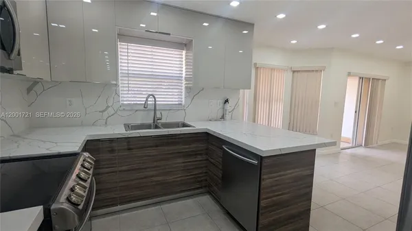 a kitchen that has a sink and a stove