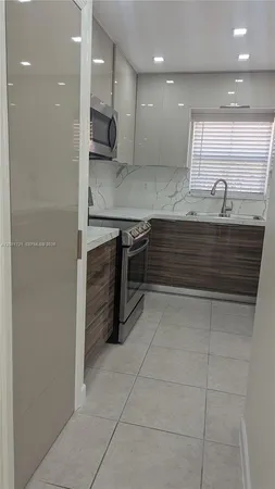 a kitchen with a sink stainless steel appliances and cabinets