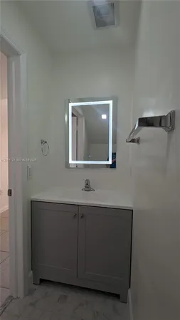 a white toilet sitting next to a shower