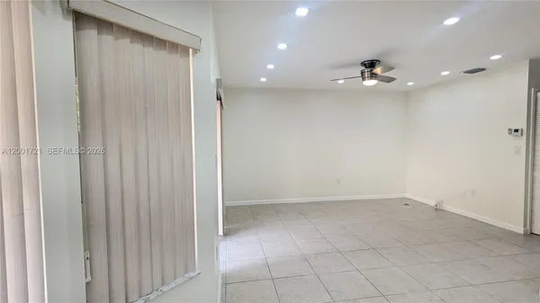 an empty room with a empty space and windows