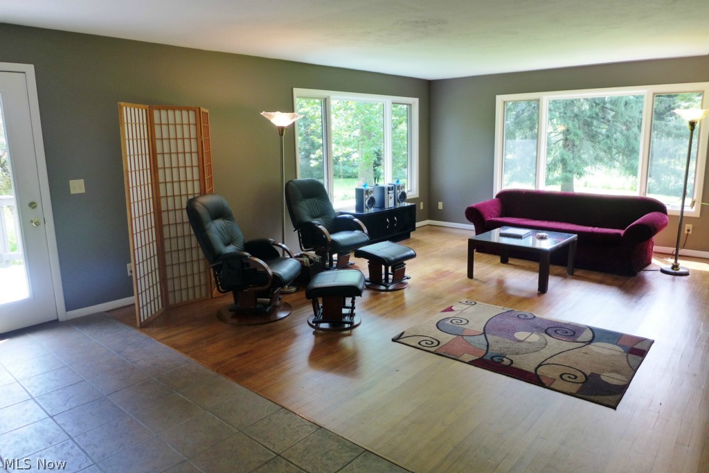 7609 Dines Road Novelty, OH 44072 - Photo 7 of 25 Tile, hardwood, large windows and a fireplace MAKE this room! The door to the left leads to the deck!