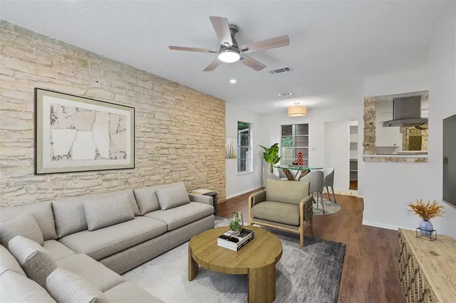 a living room with furniture and kitchen view