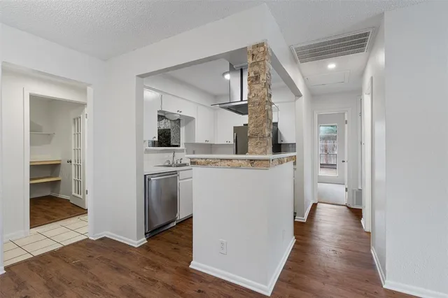 a view of a kitchen cabinets and wooden floor