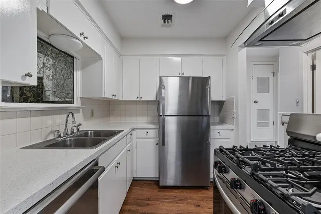 a kitchen with a refrigerator and a sink