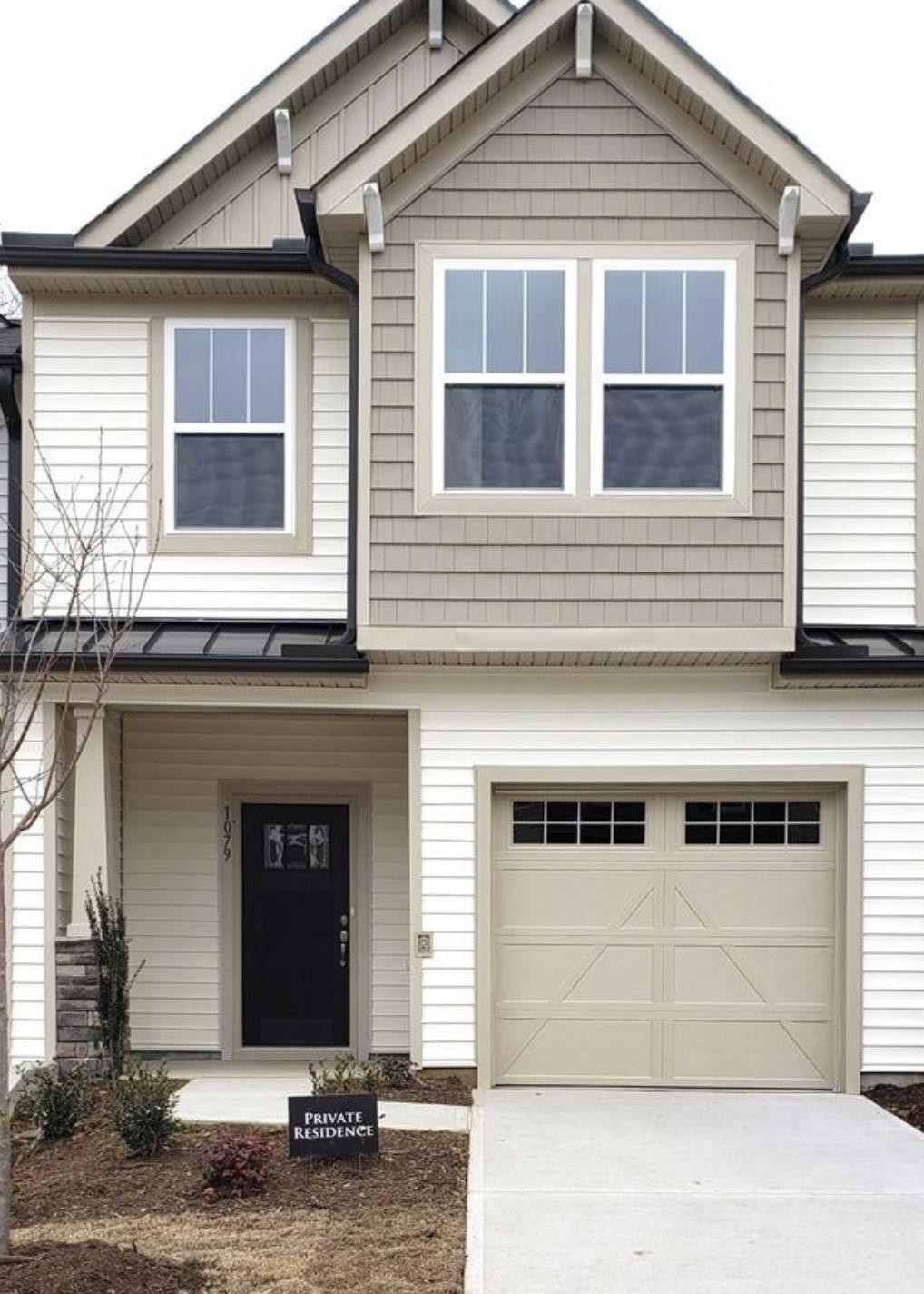 a front view of a house with a garage