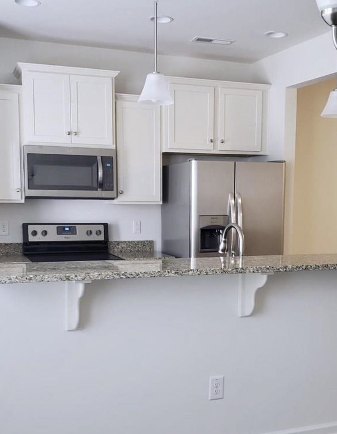 1079 Coldstream Drive Burlington, NC 27215 - Photo 2 of 4 a kitchen with stainless steel appliances granite countertop a sink and a stove top oven