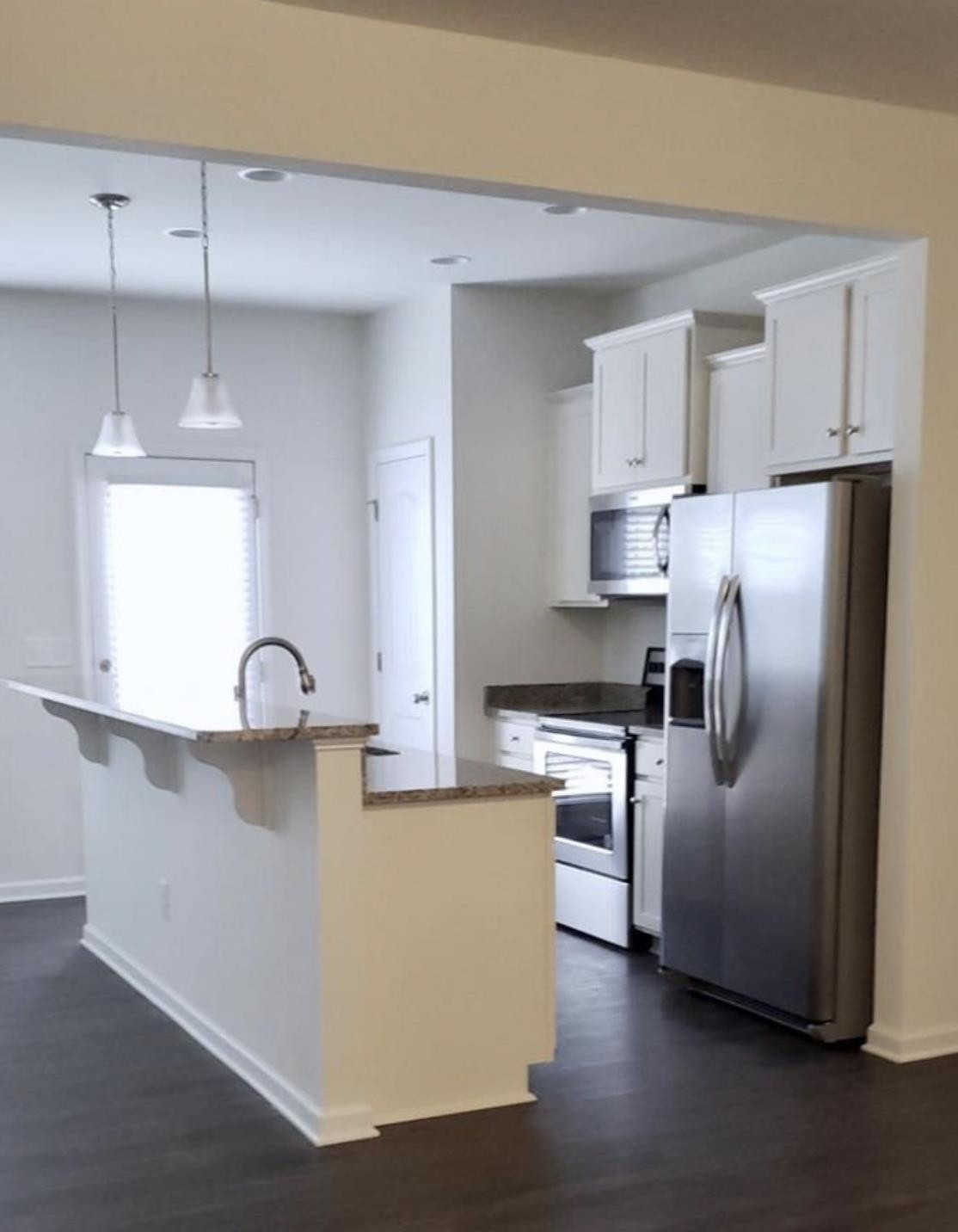 1079 Coldstream Drive Burlington, NC 27215 - Photo 3 of 4 a kitchen with stainless steel appliances granite countertop a refrigerator a sink a stove and white cabinets