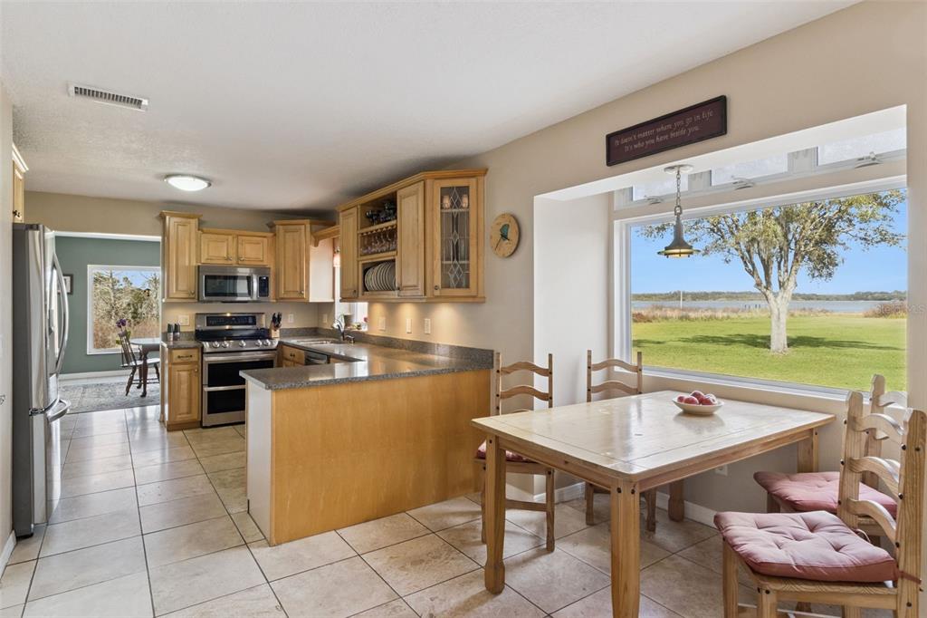 1256 Center Street Dundee, FL 33838 - Photo 11 of 41 a kitchen with a stove a sink and a refrigerator