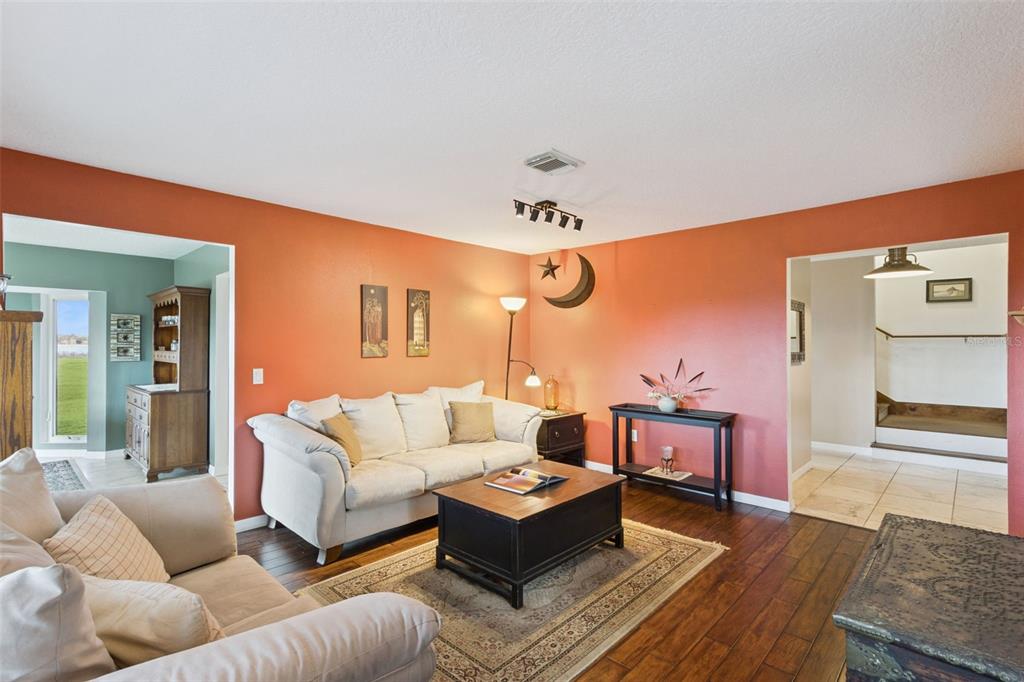 1256 Center Street Dundee, FL 33838 - Photo 16 of 41 a living room with furniture a wooden floor and a large window
