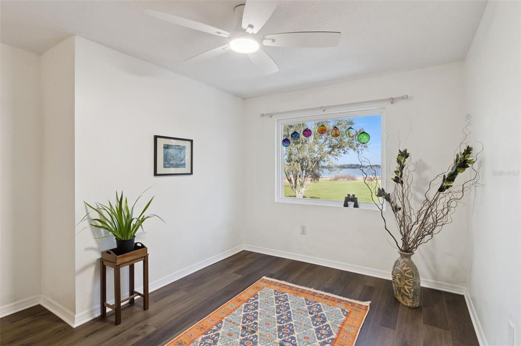 1256 Center Street Dundee, FL 33838 - Photo 18 of 41 a view of a room with wooden floor and a potted plant
