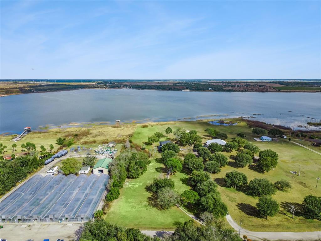 1256 Center Street Dundee, FL 33838 - Photo 2 of 41 a view of a lake with houses in the back