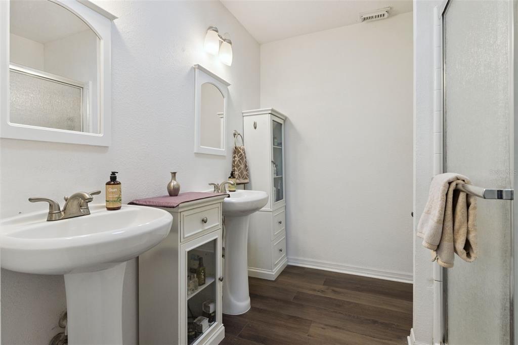 1256 Center Street Dundee, FL 33838 - Photo 23 of 41 a spacious bathroom with a double vanity sink a mirror and shower