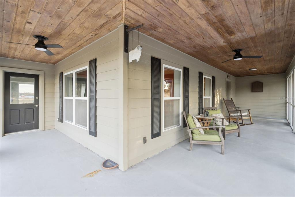 1256 Center Street Dundee, FL 33838 - Photo 31 of 41 a view of a patio with table and chairs and a barbeque