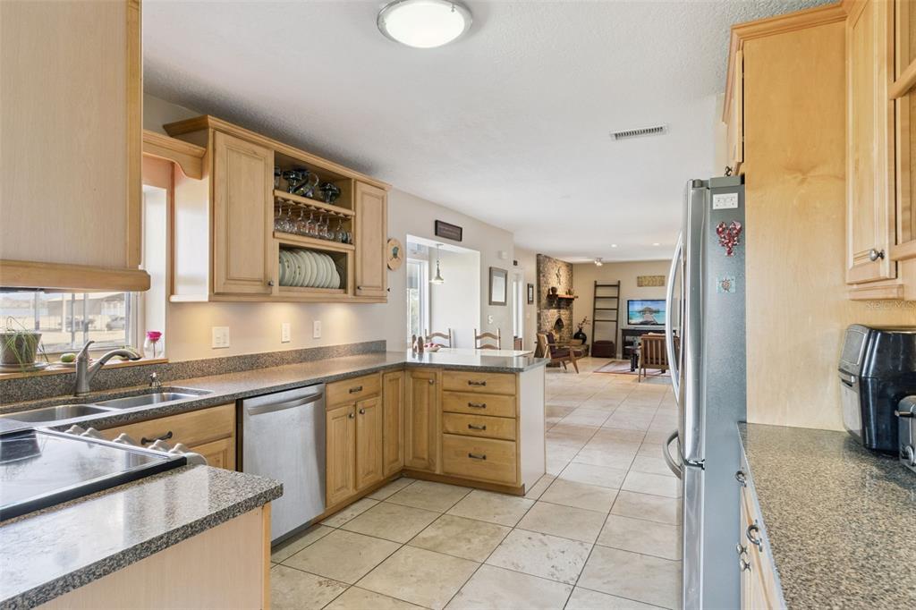 1256 Center Street Dundee, FL 33838 - Photo 6 of 41 a kitchen with stainless steel appliances granite countertop a sink and cabinets