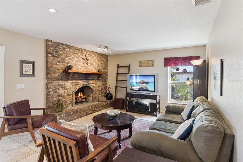 1256 Center Street Dundee, FL 33838 - Photo 10 of 41 a living room with furniture flat screen tv and a fireplace