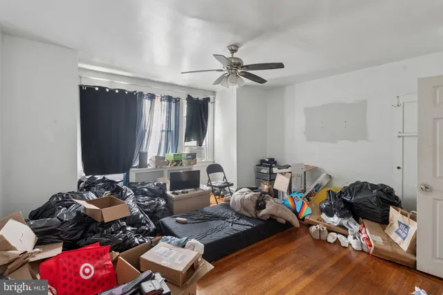 a living room with furniture a flat screen tv and a window