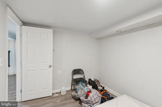 a view of a room that has a bed and a dresser in it
