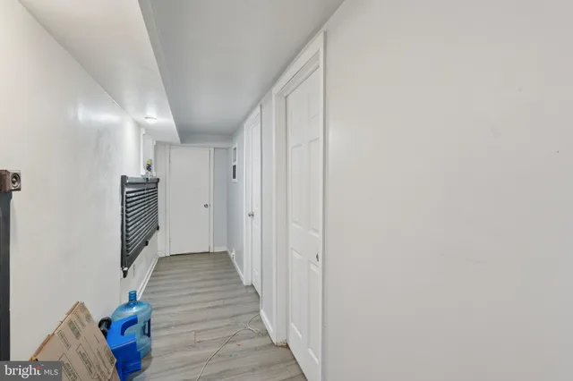 a view of hallway with stairs and wooden floor