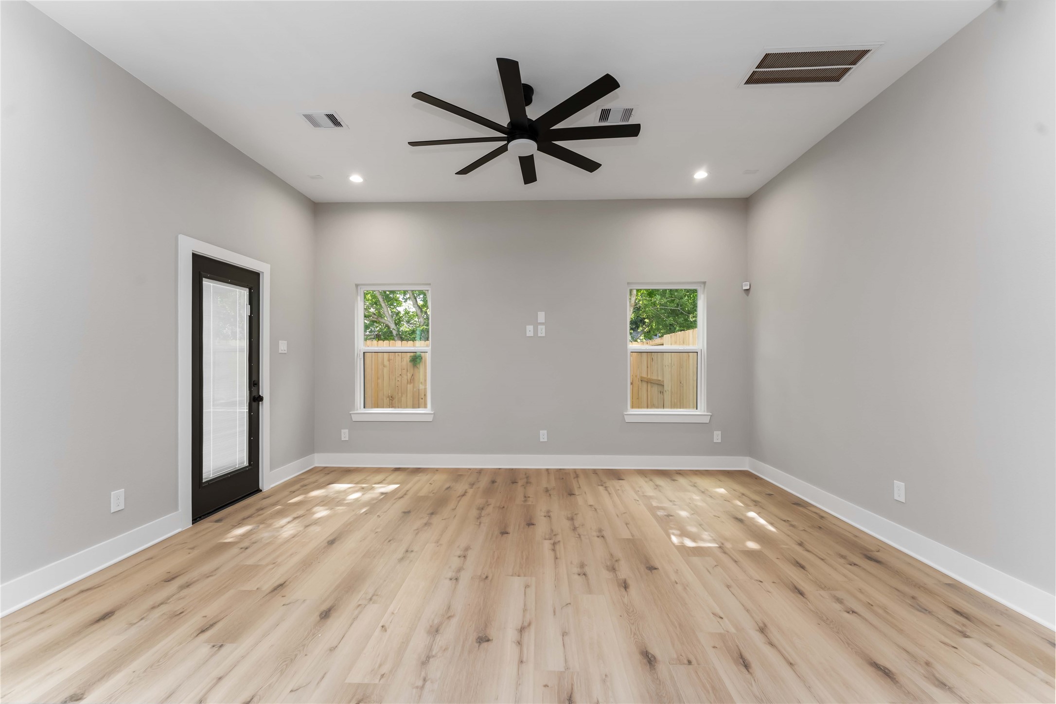 4201 Mallow Street Houston, TX 77051 - Photo 4 of 23 a view of room with window ceiling fan and wooden floor