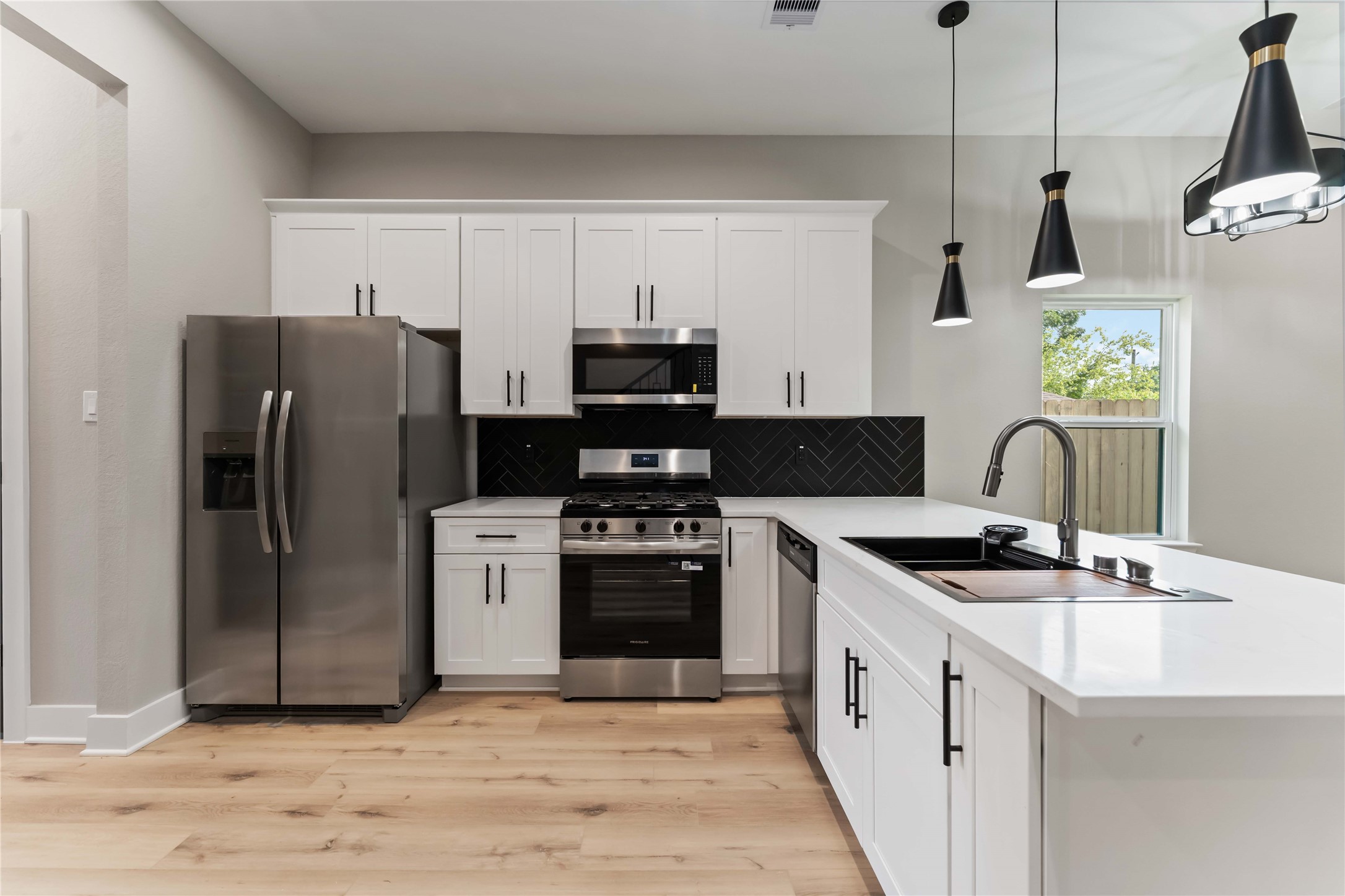 4201 Mallow Street Houston, TX 77051 - Photo 6 of 23 a kitchen with stainless steel appliances granite countertop a refrigerator a stove a sink and a microwave