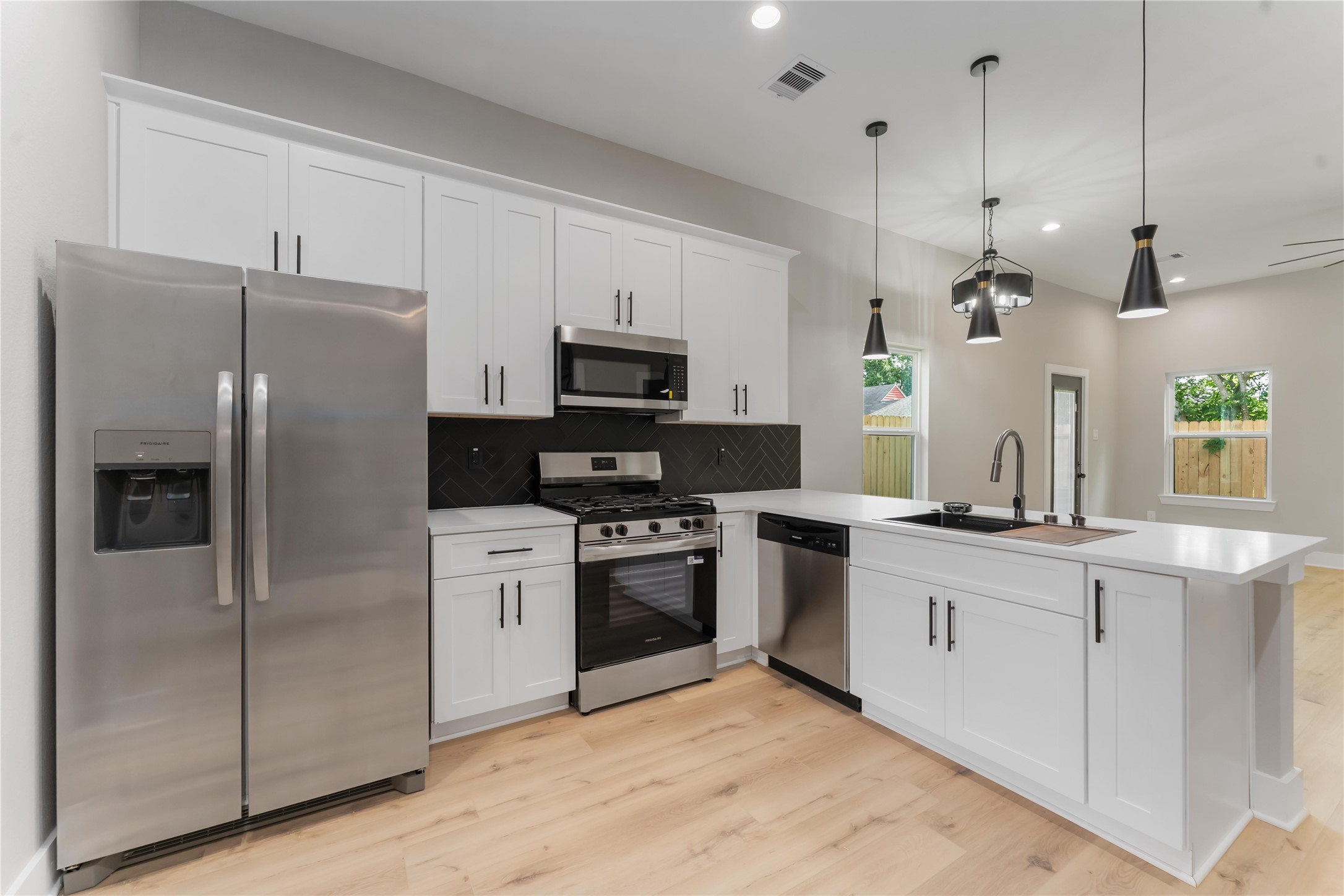 4201 Mallow Street Houston, TX 77051 - Photo 7 of 23 a kitchen with stainless steel appliances a refrigerator sink and microwave
