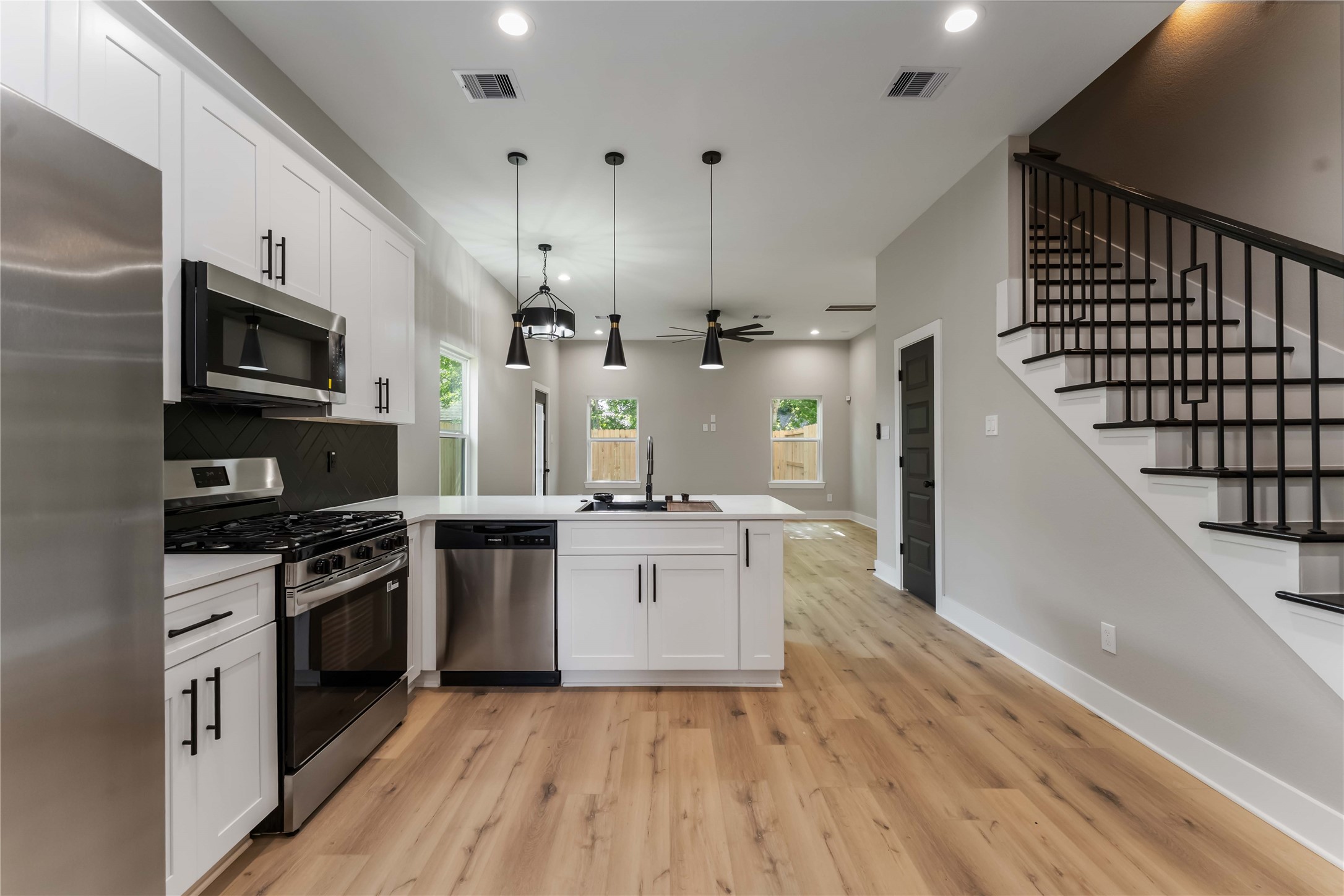 4201 Mallow Street Houston, TX 77051 - Photo 8 of 23 a kitchen with stainless steel appliances kitchen island granite countertop a stove a sink and a refrigerator