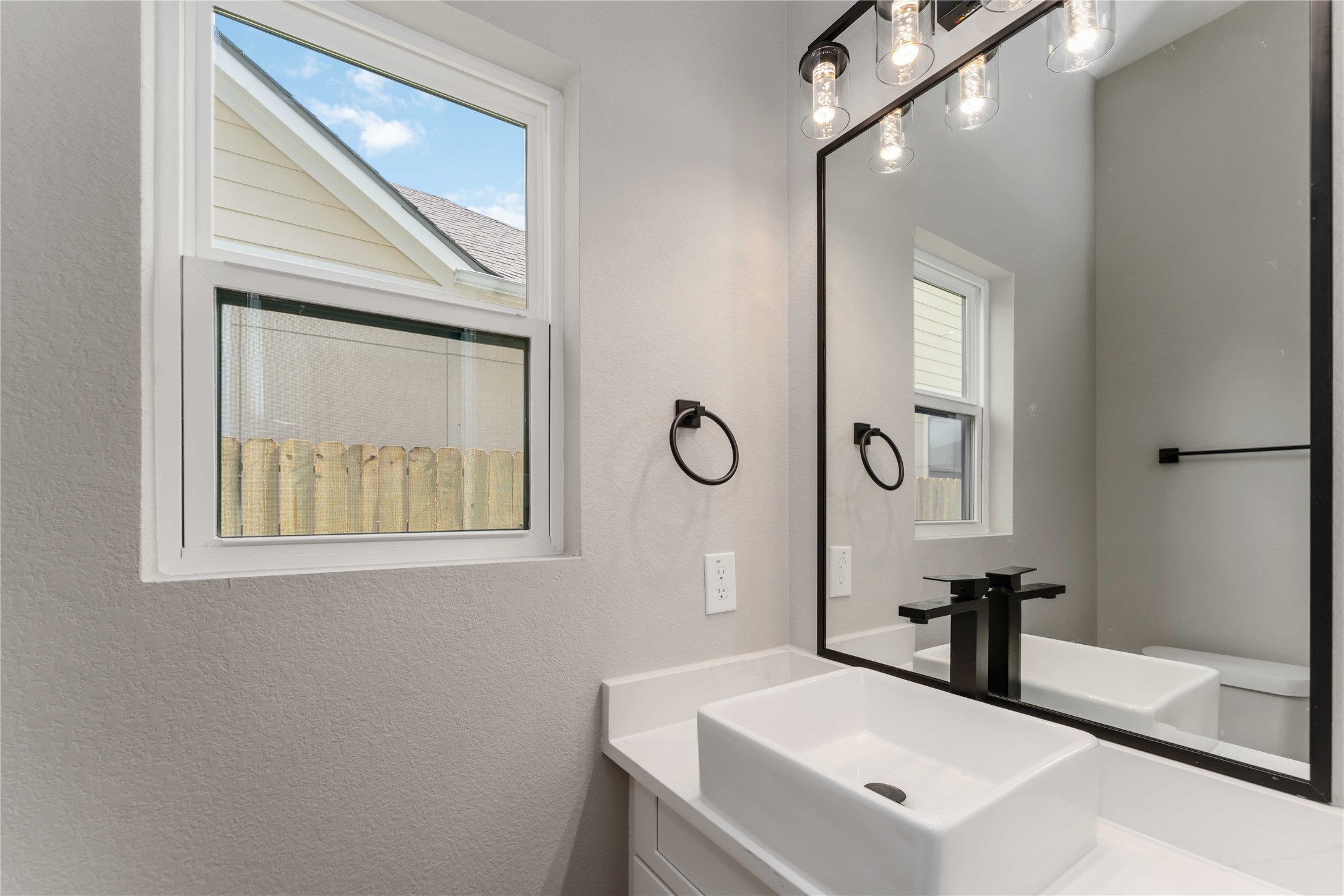 4201 Mallow Street Houston, TX 77051 - Photo 9 of 23 a bathroom with a sink a mirror and a shower