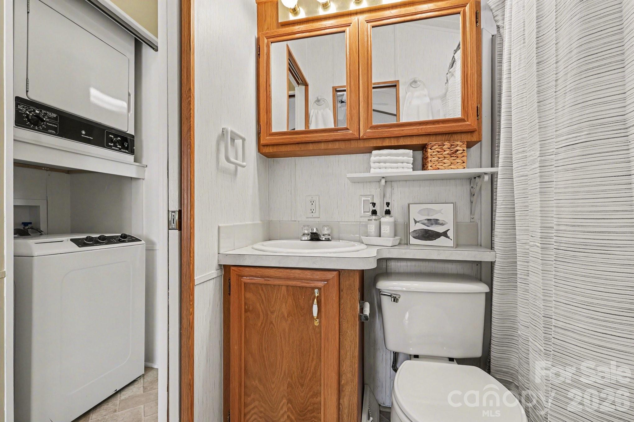 122 Maple Street New London, NC 28127 - Photo 11 of 29 a utility room with dryer washer and a view of living room