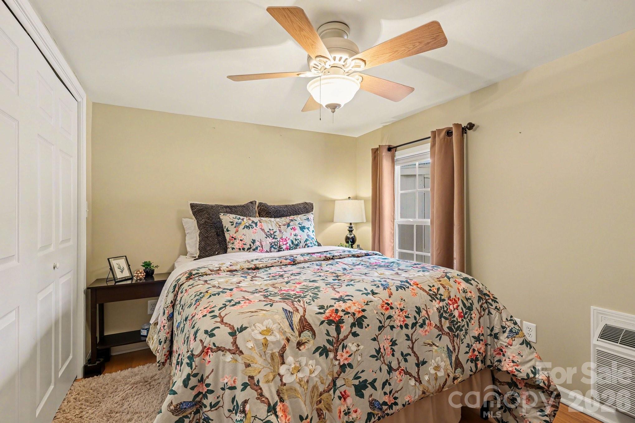 122 Maple Street New London, NC 28127 - Photo 12 of 29 a bedroom with a bed and a chandelier