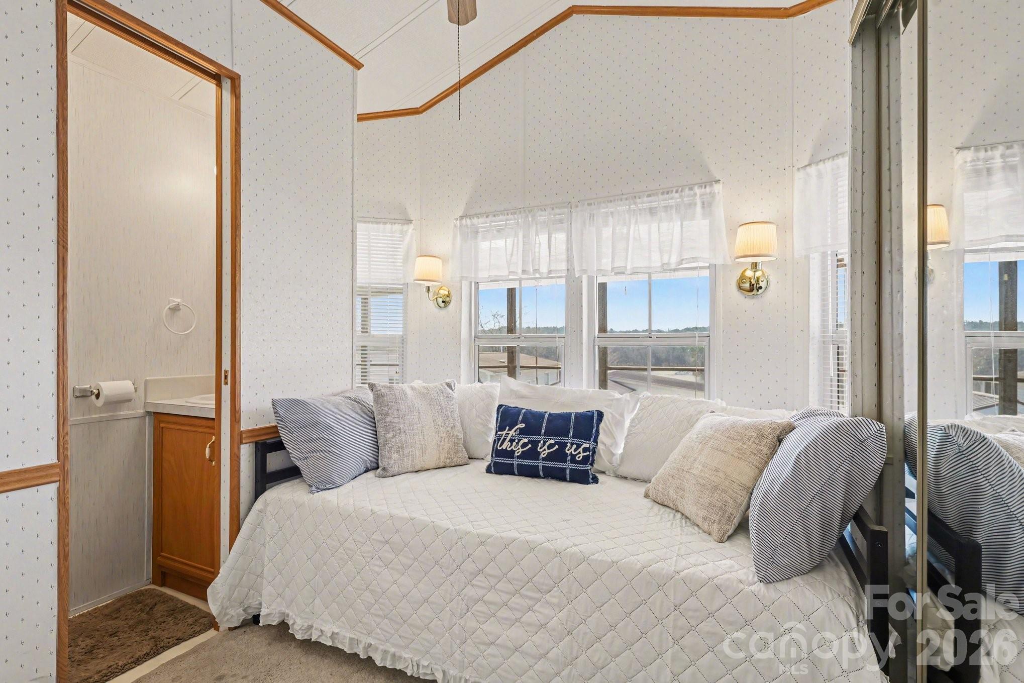 122 Maple Street New London, NC 28127 - Photo 13 of 29 a bedroom with a large bed and a window