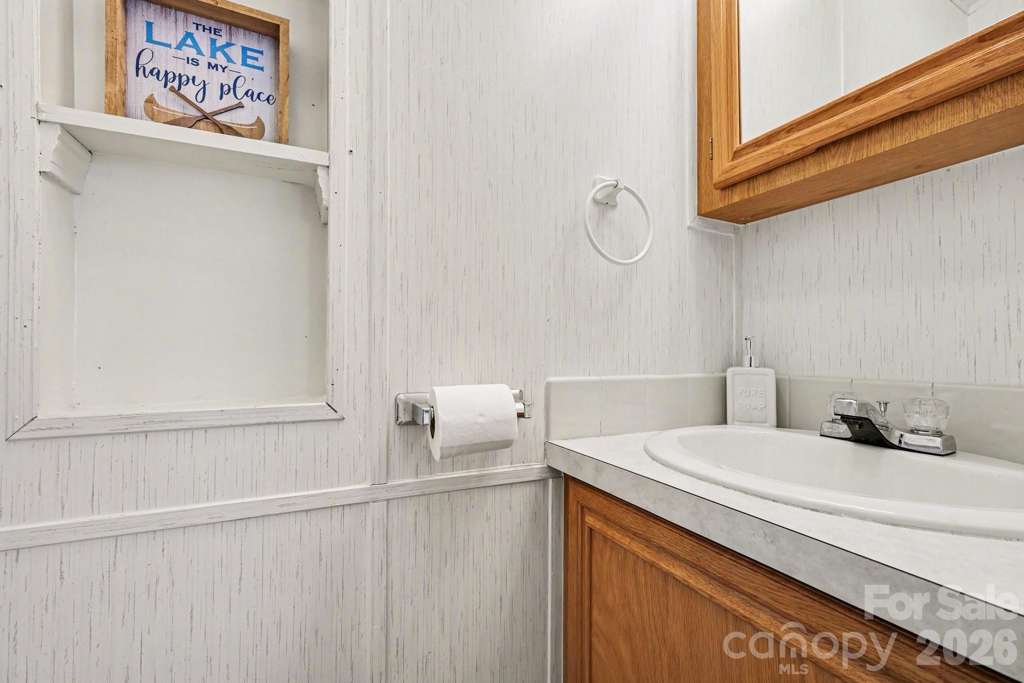 122 Maple Street New London, NC 28127 - Photo 15 of 29 a bathroom with a sink and a mirror