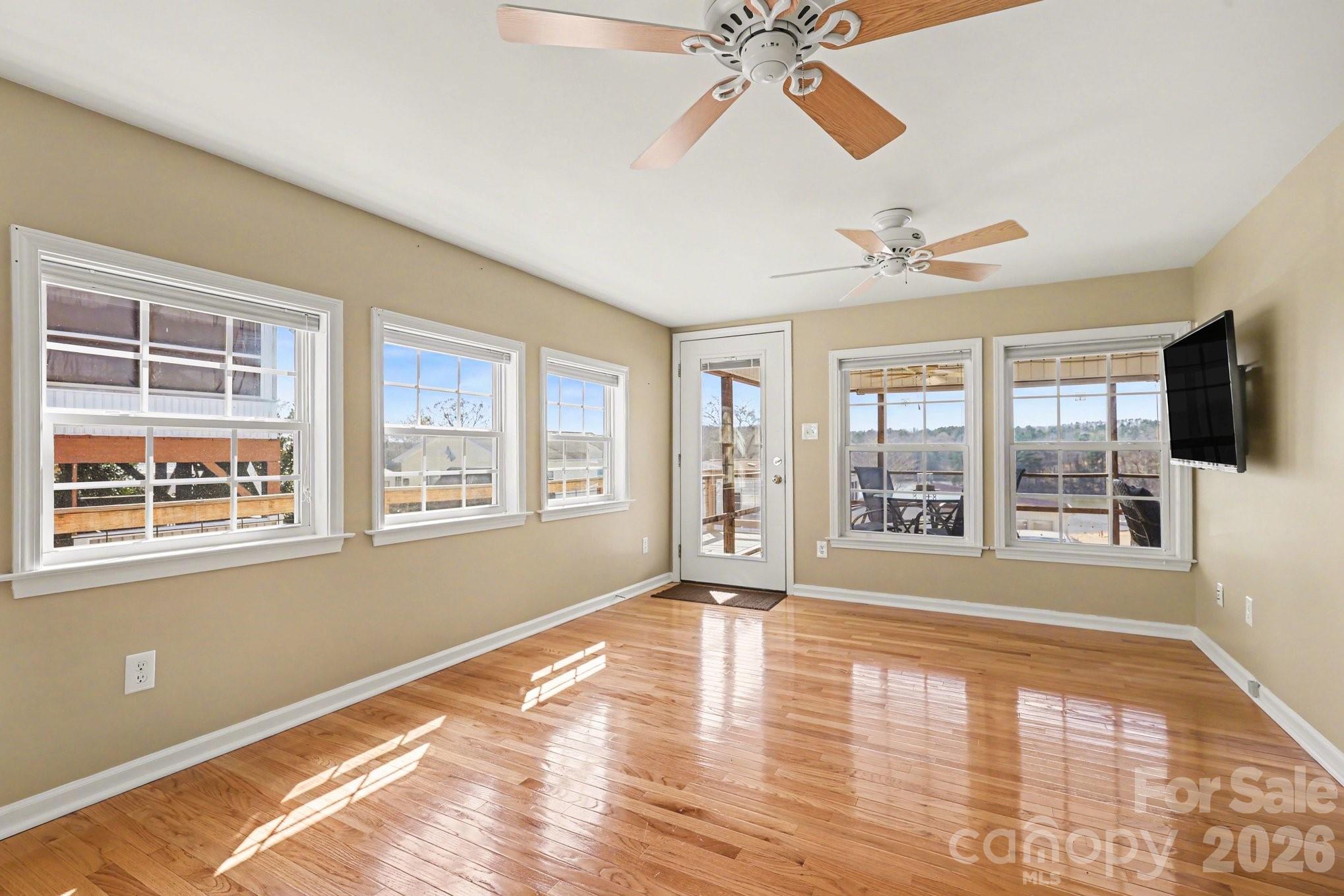 122 Maple Street New London, NC 28127 - Photo 6 of 29 a view of an empty room with a window and wooden floor