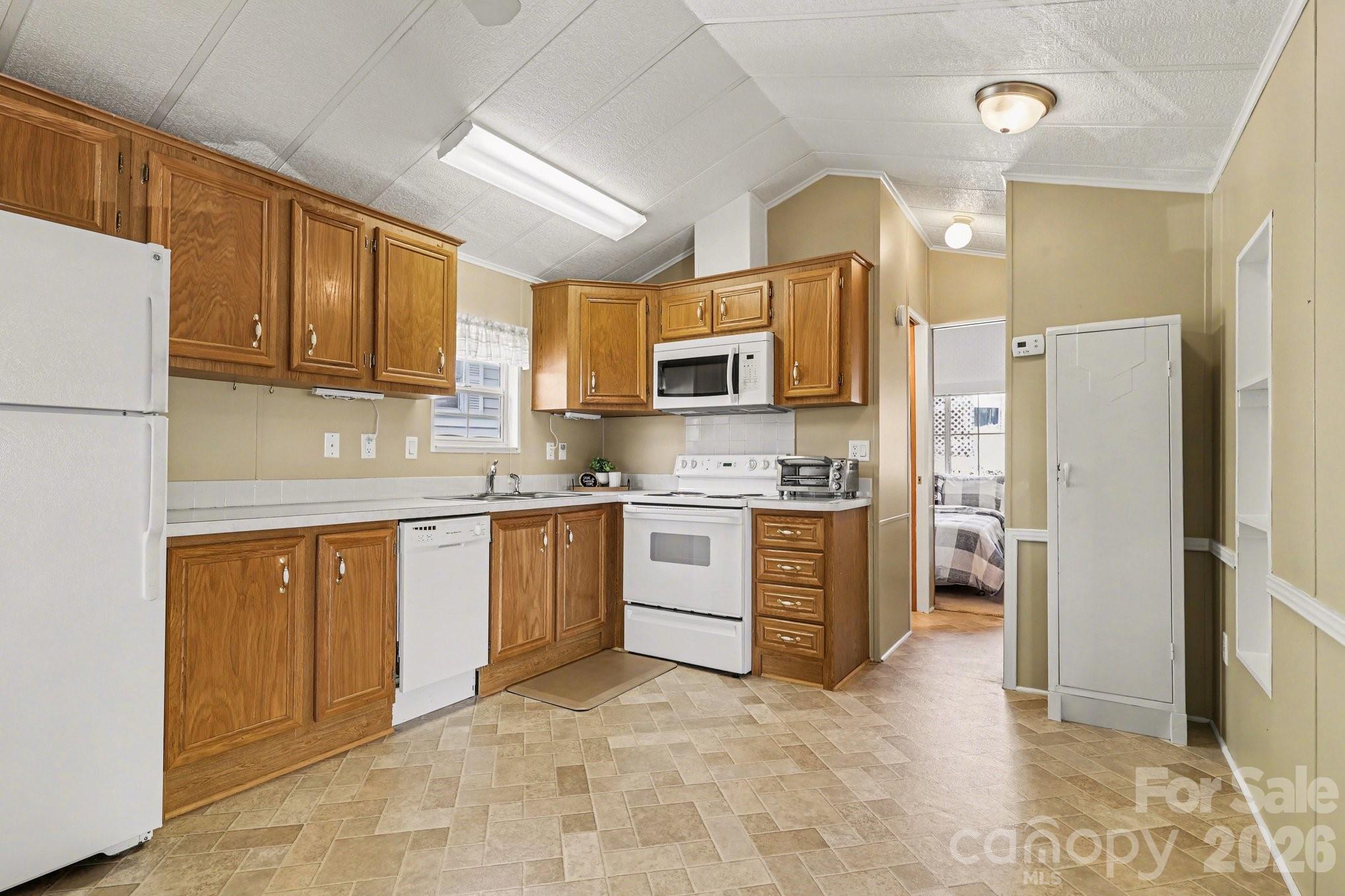 122 Maple Street New London, NC 28127 - Photo 7 of 29 a kitchen with a refrigerator stove top oven and sink