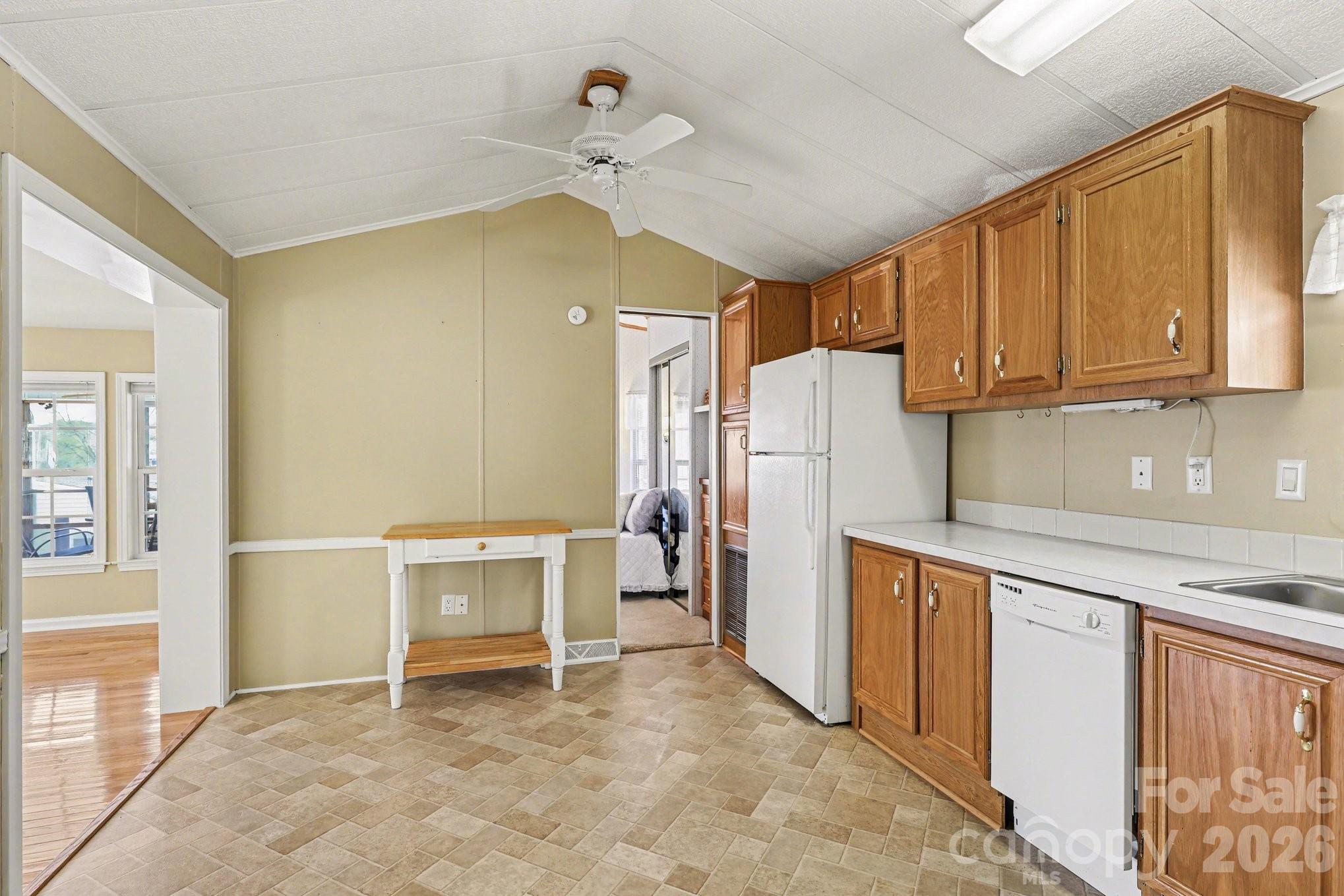 122 Maple Street New London, NC 28127 - Photo 8 of 29 a kitchen with a refrigerator and a sink