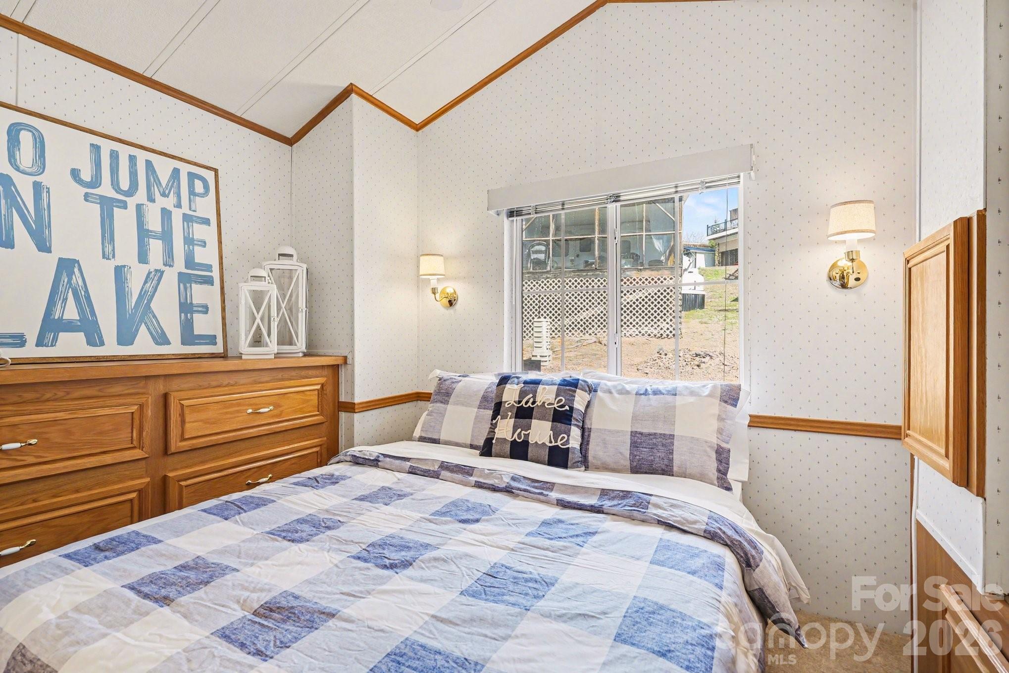 122 Maple Street New London, NC 28127 - Photo 9 of 29 a bedroom with a bed and wooden floor