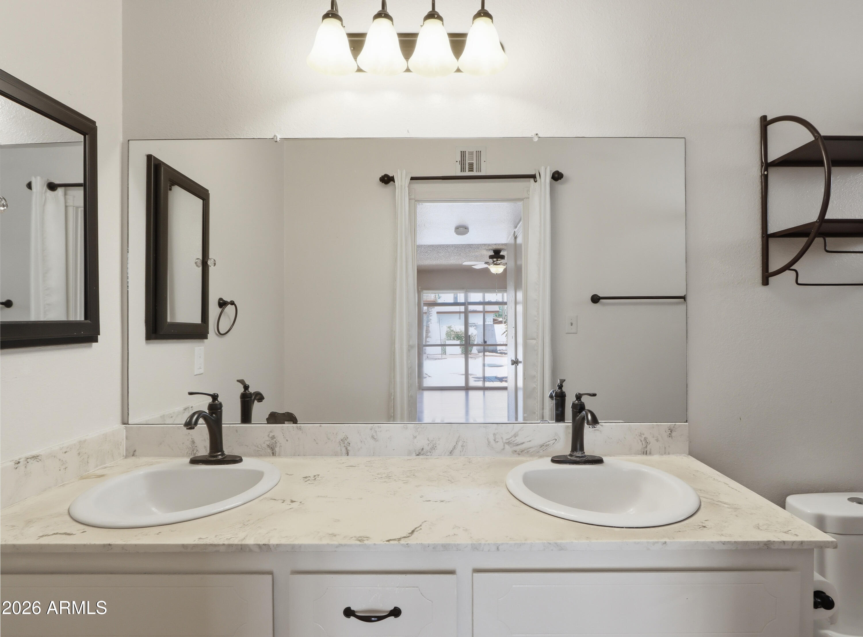 450 Cascada Road Litchfield Park, AZ 85340 - Photo 19 of 40 a bathroom with double vanity sinks and a mirror