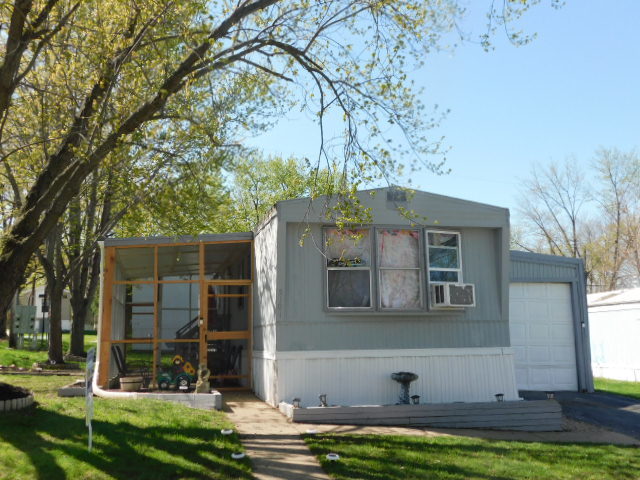 5101 Pebble Lane Loves Park, IL 61111 - Photo 1 of 17 a front view of a house with garden