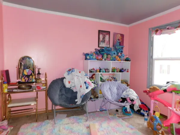 a bed room with a bed and a chair