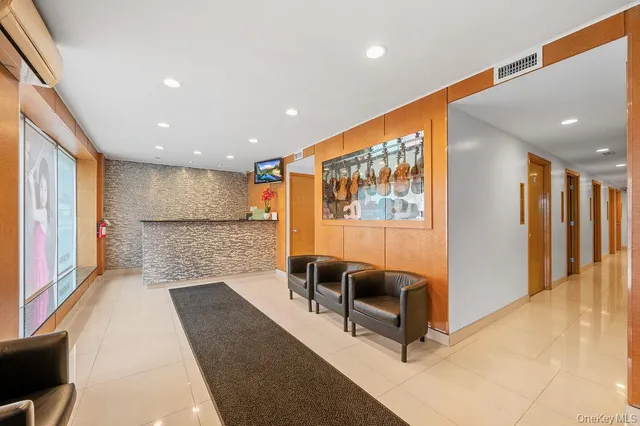 a lobby with furniture and a rug