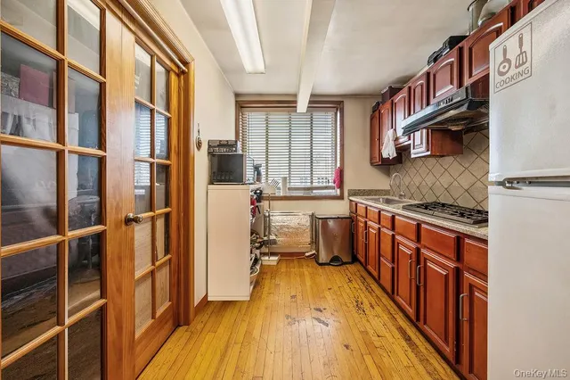 a view of an entryway with wooden floors