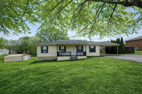a house view with a sitting space and garden