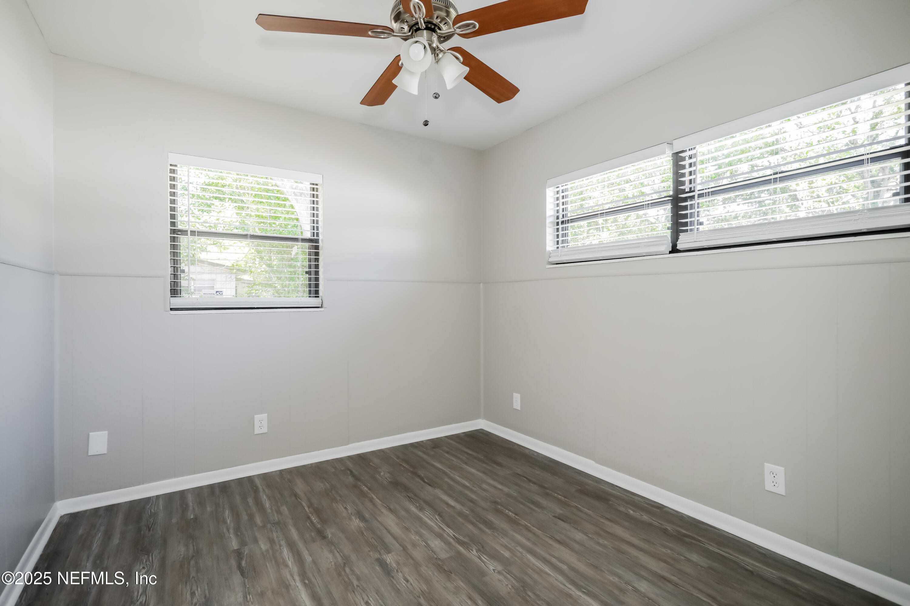 7428 Centauri Road Jacksonville, FL 32210 - Photo 12 of 15 wooden floor in an empty room with a window