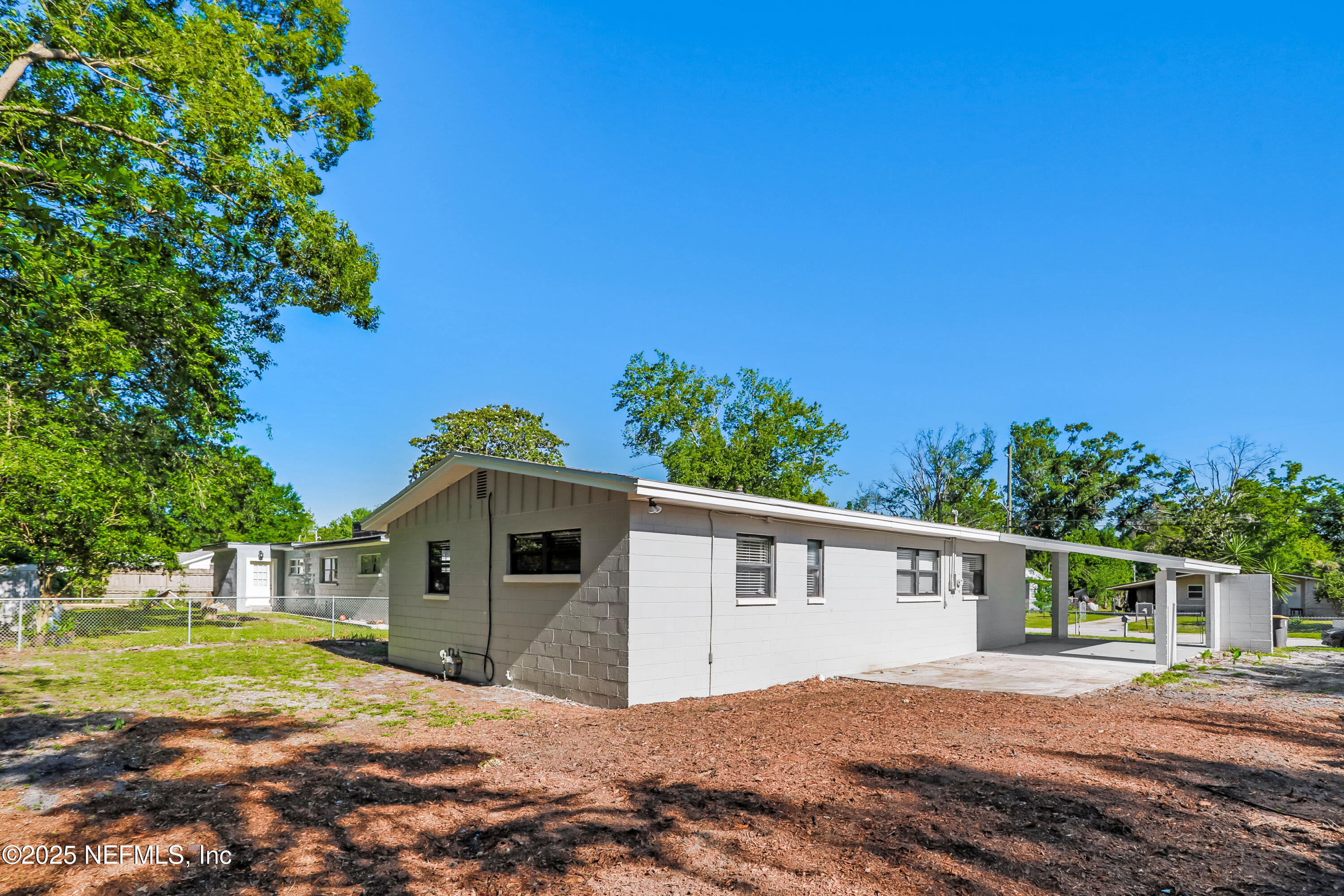 7428 Centauri Road Jacksonville, FL 32210 - Photo 14 of 15 a front view of a house with a yard and garage